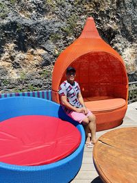 Woman sitting by swimming pool