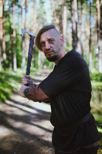 Portrait of young man exercising in park