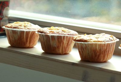 Close-up of cupcakes on window sill