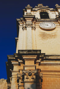 Low angle view of traditional building against clear blue sky