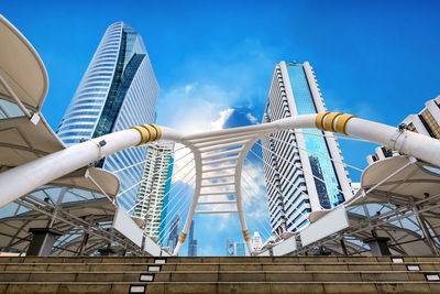 Low angle view of modern building against blue sky