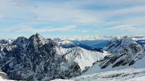 Panoramic view of snowcapped mountains against sky