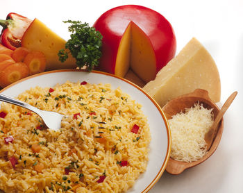 Close-up of fried rice with ingredients over white background