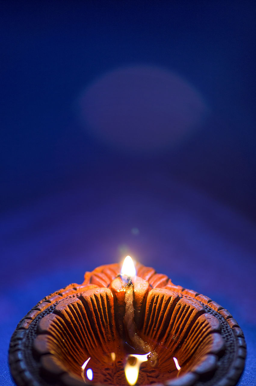 CLOSE-UP OF ILLUMINATED LAMP AGAINST STAR