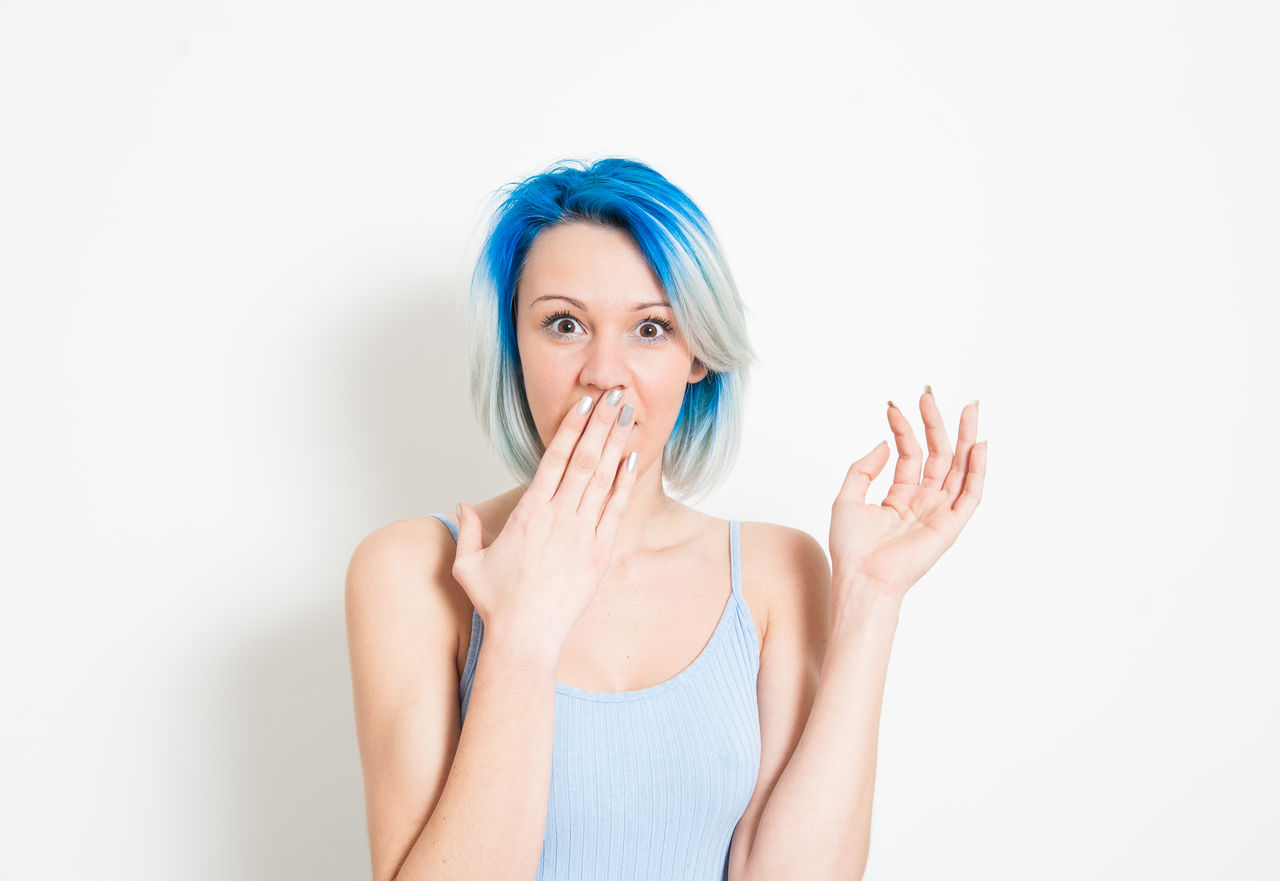 PORTRAIT OF BEAUTIFUL WOMAN AGAINST WHITE BACKGROUND