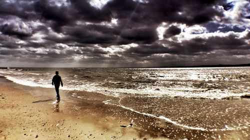 Scenic view of sea against cloudy sky