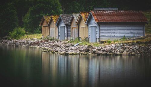 House by river against building