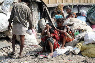 Group of people on garbage outdoors