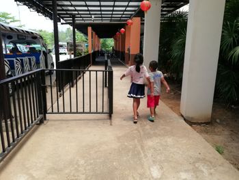 Rear view of people walking on corridor