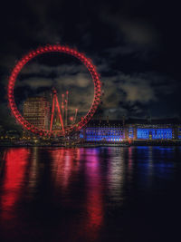 View of illuminated ferris wheel at night