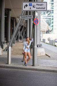Full length of young woman on road