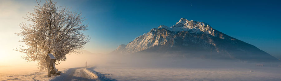 Scenic view of frozen mountain against clear sky