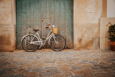 Bicycle parked on wall of building