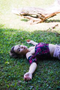 Portrait of teenage girl lying down on grass