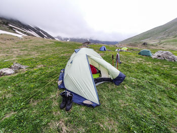 Tent on field against sky