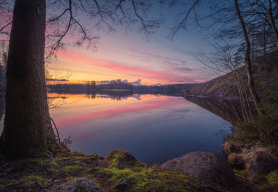 Scenic view of lake against romantic sky at sunset