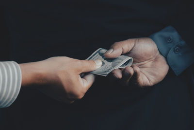 Midsection of man holding hands