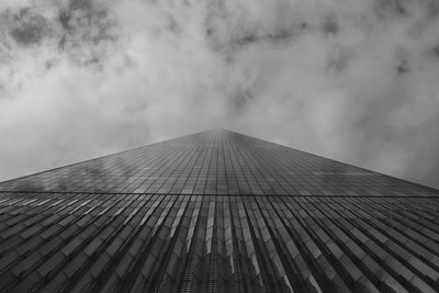Low angle view of modern building against cloudy sky