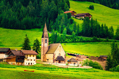 Scenic view of church on field in forest
