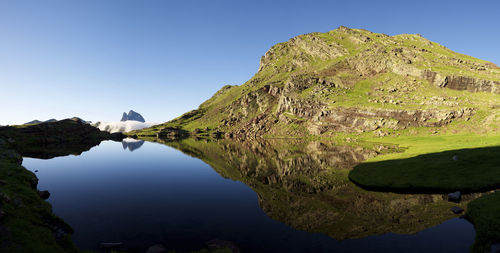 Ossau peak reflected in anayet lake in tena valley, huesca province in aragon, pyrenees in spain.