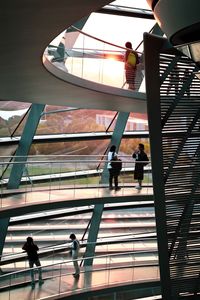 Low angle view of people walking on staircase