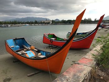 Boats moored on sea against sky