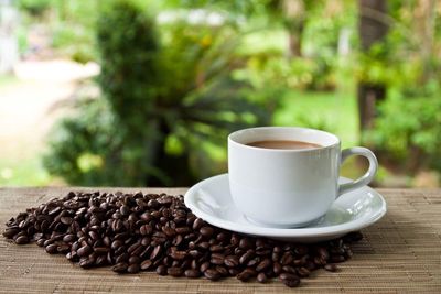 Close-up of coffee and beans on table