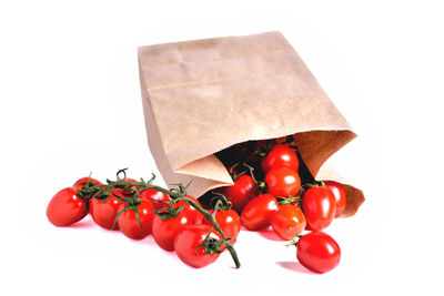 High angle view of cherry tomatoes against white background