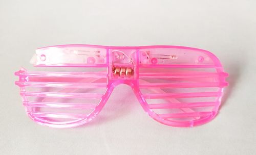 Close-up of eyeglasses on glass against white background