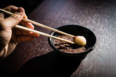 Close-up of person holding ice cream in bowl