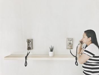 Man using smart phone against white background