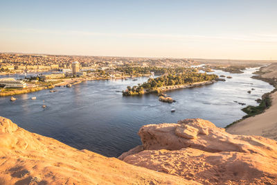 High angle view of sea and cityscape against sky