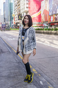 Portrait of smiling woman on road in city