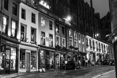 Street amidst buildings at night