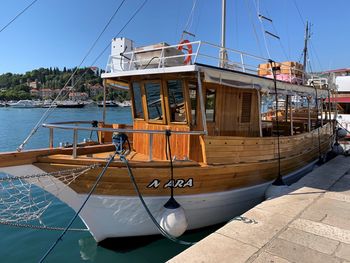 Sailboats moored on sea against clear sky