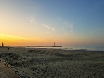 Scenic view of beach against sky during sunset