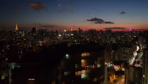 Aerial view of city lit up at night