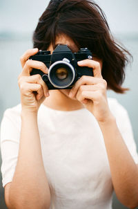 Midsection of woman photographing