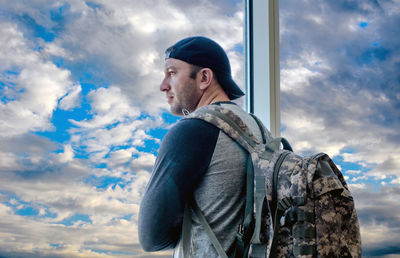 Young man with a back pack waiting for a plane at the airport