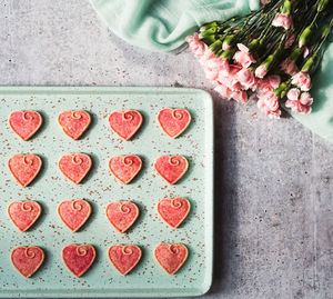 Overhead view of valentine's day heart cookies cooling on a pan.