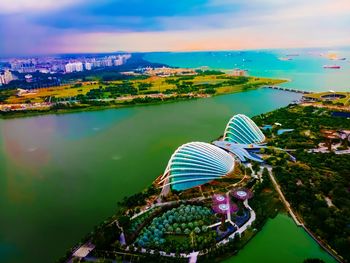 High angle view of buildings by sea against sky