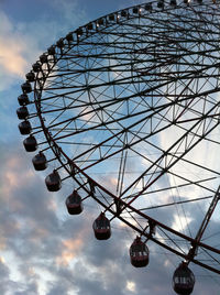 Low angle view of ferris wheel against sky