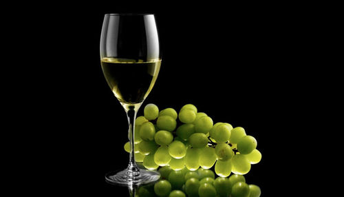 Close-up of wine in glass against black background