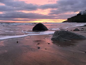 Scenic view of beach against sky during sunset