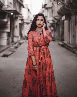 Portrait of beautiful young woman standing outdoors