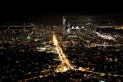 Aerial view of city lit up at night