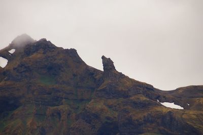 Low angle view of rock formation against sky