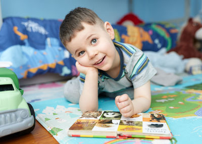 Close-up of boy playing with toy blocks at home