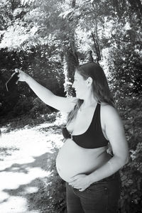 Woman standing by tree