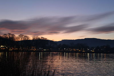 Scenic view of lake against sky during sunset